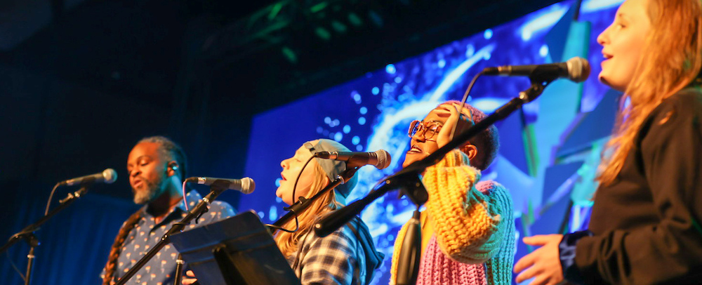 musicians leading singing from stage
